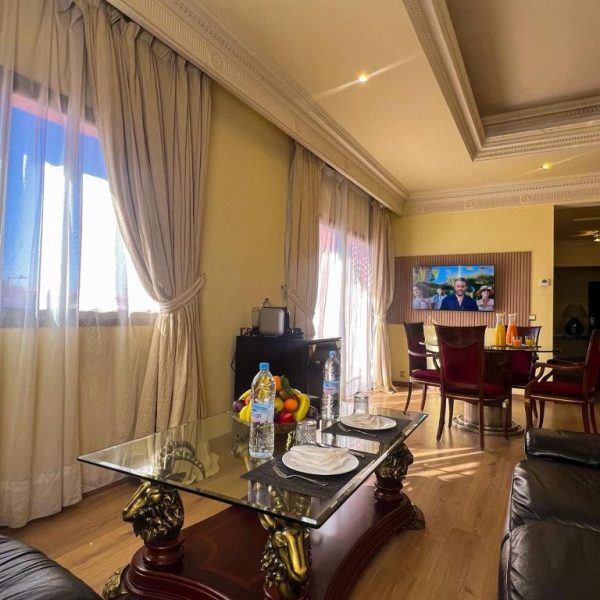 Salón comedor de lujo con mesa de cristal y decoración clásica en el Royal Mirage Deluxe