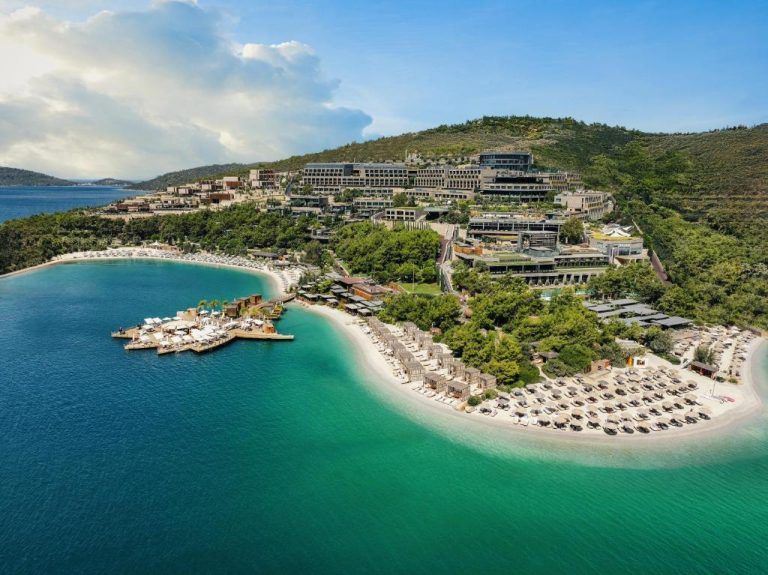 Vista aérea del Lujo Hotel Bodrum con playa privada de arena blanca y aguas turquesas en Turquía