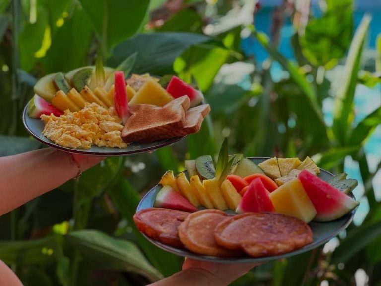 Desayuno tropical con frutas frescas, tostadas y huevos revueltos servido en el Hotel Good Life
