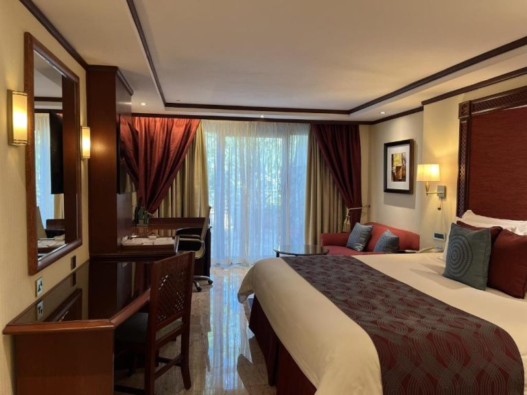 Habitación deluxe con cama king size y decoración elegante en el Nairobi Serena Hotel