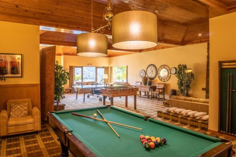 Sala de juegos con mesa de billar, futbolín y ping pong en Lago Azul Eco Hotel
