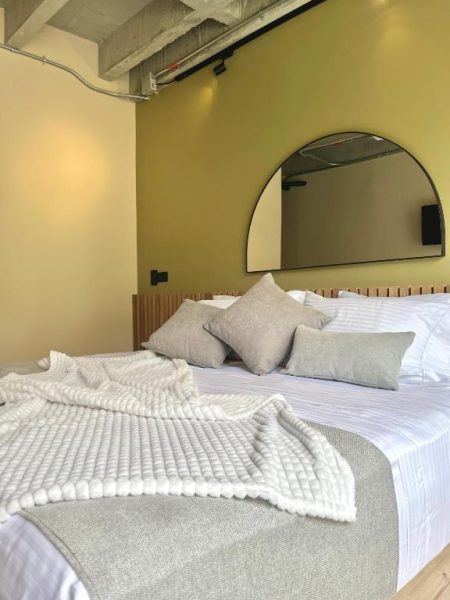 Habitación doble con cama king y espejo de arco en Hotel Beminimal Parques