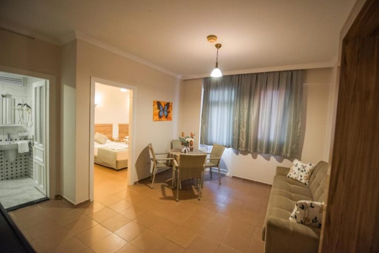 Salón comedor con zona de estar y acceso a dormitorio y baño en Narcis Apart Hotel