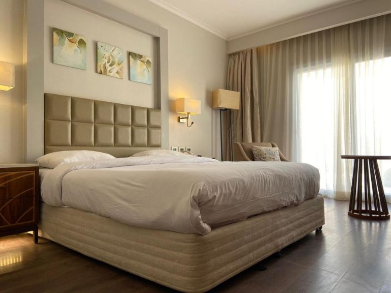 Habitación doble con cama king size y cabecero acolchado en Hotel Studio