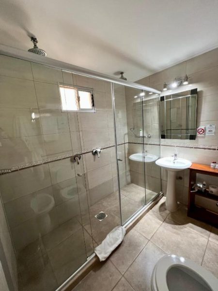Baño privado con ducha de cristal y lavabo del Hotel FK Paso de los Toros Boutique