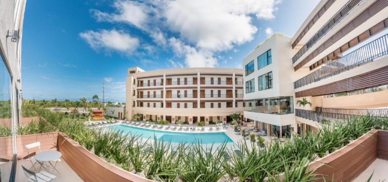 Piscina exterior con tumbonas del Hotel Faranda Single 1 Punta Cana Adults Only con vistas al edificio