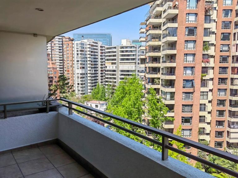 Terraza con vistas a edificios residenciales y árboles del Apart Barrio El Golf con piscina en Santiago