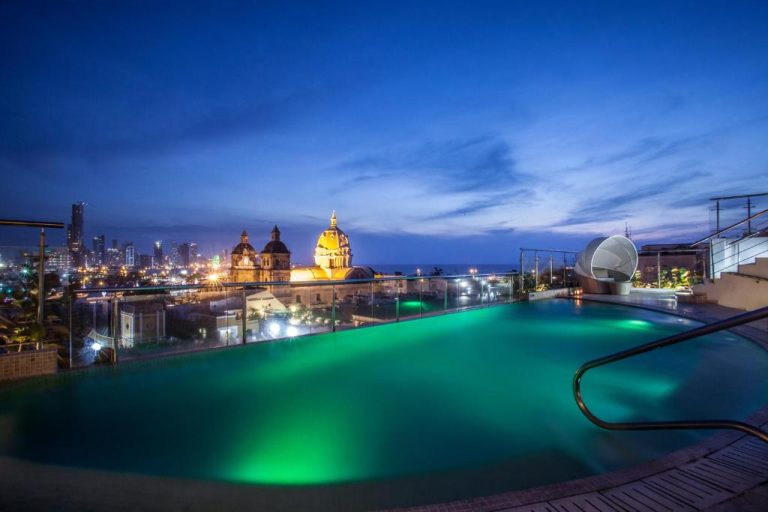 Piscina rooftop iluminada del Movich Hotel Cartagena de Indias con vista panorámica a la ciudad y catedral