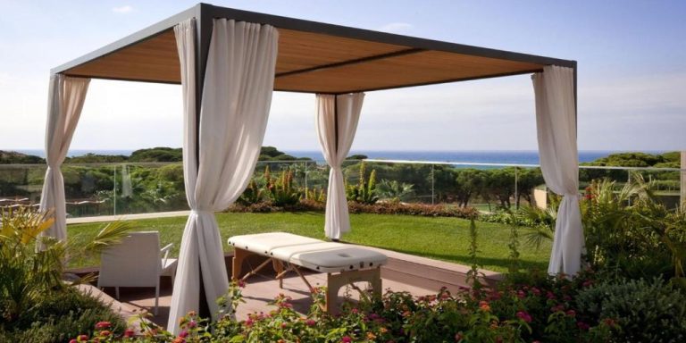 Cabana de spa al aire libre con camilla de masajes y vistas al mar en EPIC SANA Algarve Hotel
