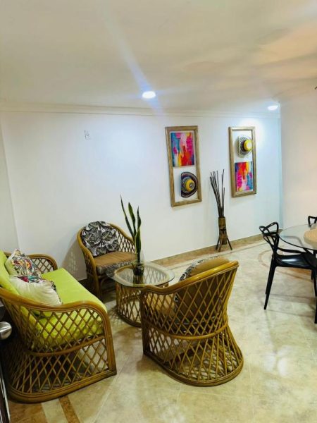 Sala de estar con sillones de ratán y decoración tropical en Hotel Marie Real Cartagena