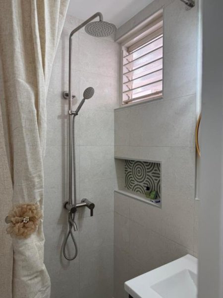 Ducha de lluvia con columna de hidromasaje en el baño moderno del Ninth River Ocho Rios