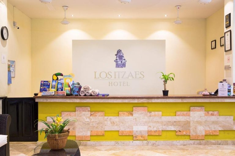 Recepción principal del Hotel Los Itzaes by 5th Av con mostrador decorado al estilo maya