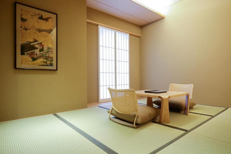 Habitación tradicional japonesa con tatami y mesa baja en Kaminarimon Ryokan