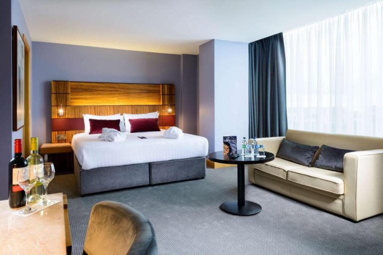 Suite con cama doble, sofá y mesa auxiliar en el Radisson Blu Hotel Athlone, Irlanda
