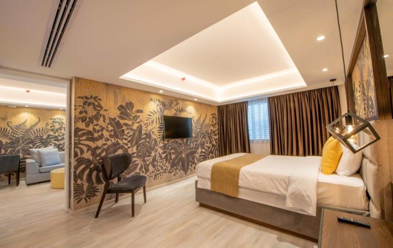 Suite elegante con cama doble y mural tropical en Almond Business Hotel
