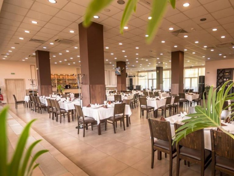 Amplio restaurante interior del Park Hotel Kyustendil con mesas vestidas de blanco y decoración elegante