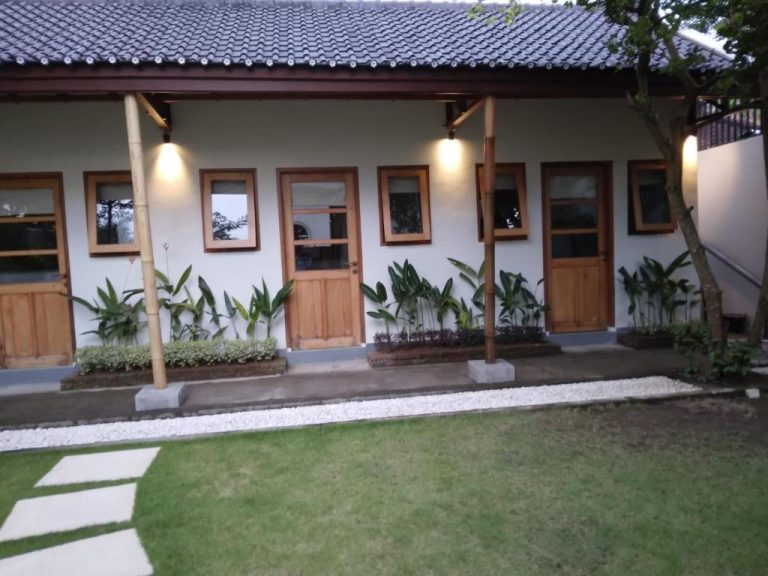 Fachada exterior con jardín y bungalows de madera del Roots Hotel Senggigi en Lombok