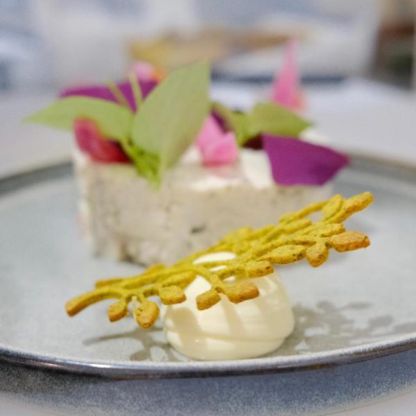Postre gourmet con decoración floral y crema artesanal en el restaurante del Maison Victoire Boutique Hôtel Pointe-à-Pitre