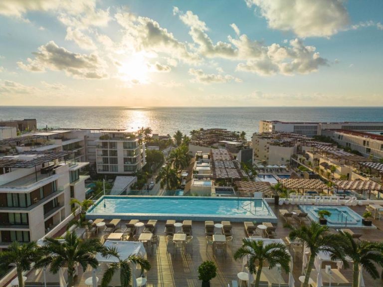 Piscina infinity rooftop con vista al mar al atardecer en The Reef 28 Hotel & Spa Adults Only