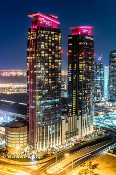 Vista nocturna de las torres iluminadas del Marriott Marquis City Center Doha con skyline de la ciudad