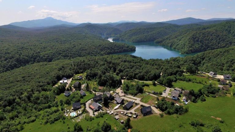 Vista aérea del Lakeside Hotel Plitvice rodeado de bosque y lago turquesa en Croacia