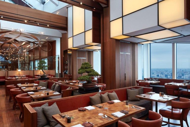 Restaurante de lujo con vistas panorámicas a Tokio y bonsáis decorativos en el Andaz Tokyo Hyatt