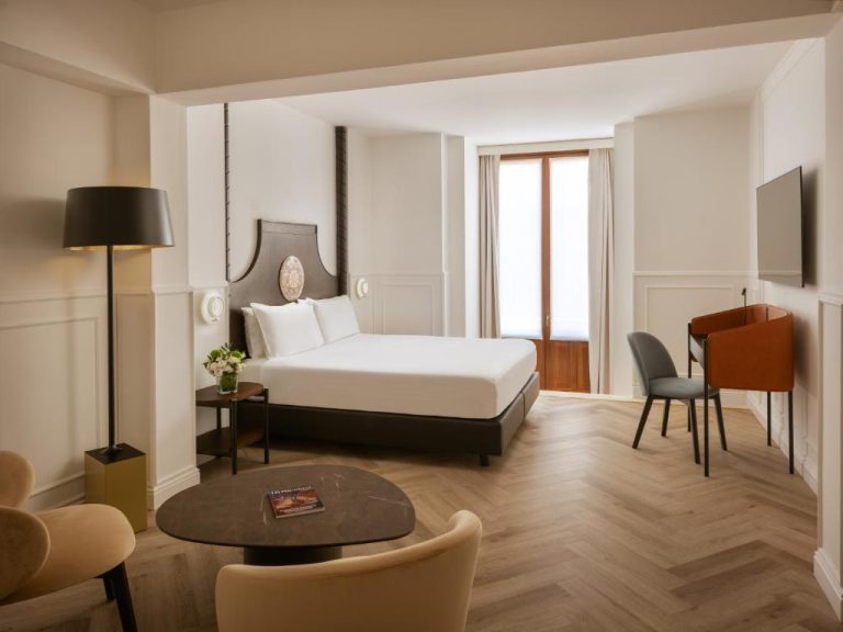 Habitación deluxe con cama doble y zona de estar elegante en Palace Catania UNA Esperienze