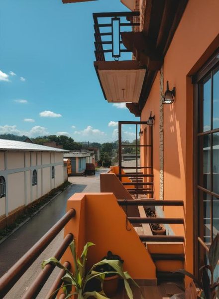 Balcón exterior con barandilla naranja y vistas al entorno del Apartotel Vera