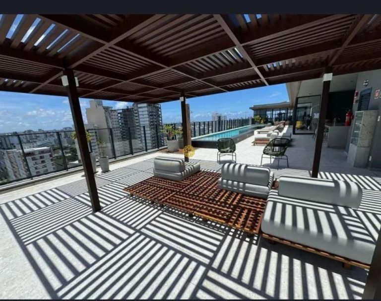 Terraza rooftop con pérgola, zona lounge y piscina en Luxuoso Flat Salvador Corredor da Vitoria