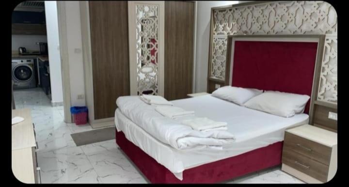 Habitación doble de lujo con cama king size y cabecero rojo en Hotel Fanadir Bay Hurghada