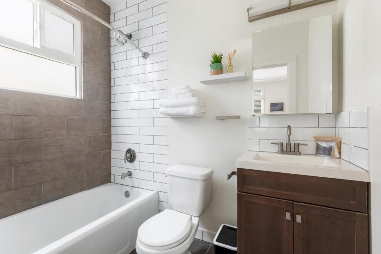 Baño completo moderno con bañera, ducha y lavabo del Beverly Grove Hotel en Los Ángeles