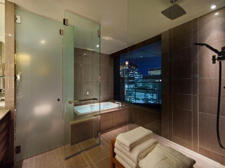 Baño de lujo con bañera y vista nocturna a Tokio en el Palace Hotel Tokyo