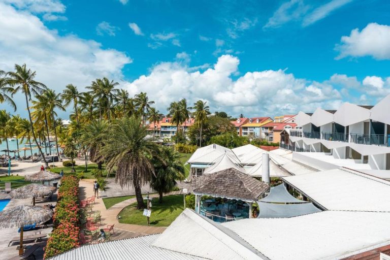 Vista aérea del Hotel Fleur d'Epee con piscina, palmeras y playa en Guadalupe
