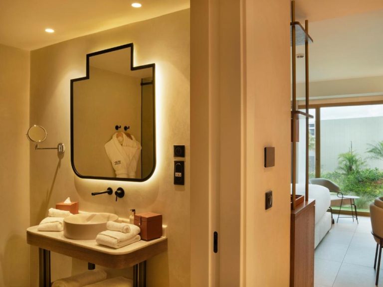 Baño moderno con espejo retroiluminado y lavabo de diseño en el hotel STORY Le Carrousel Rabat