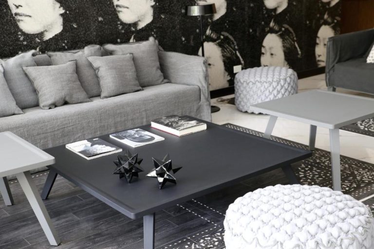 Sala de estar moderna con sofá gris y mesa de centro del Ilum Experience Home