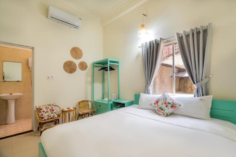 Habitación doble con cama blanca y detalles en turquesa en Y's La House, con baño privado y aire acondicionado