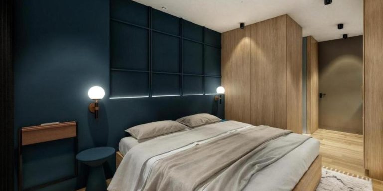 Habitación doble de lujo con pared azul y armario de madera en Autenthico Atempo Local Suites Medellín